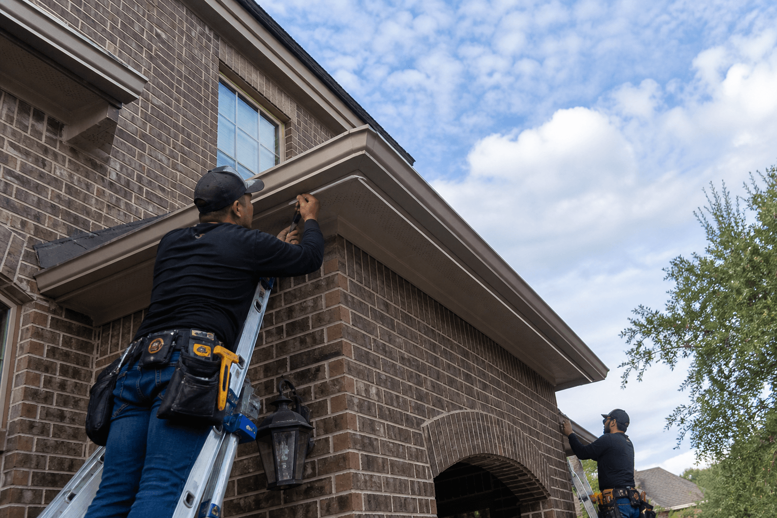 All Slopes crew installing aluminum LED track under eaves